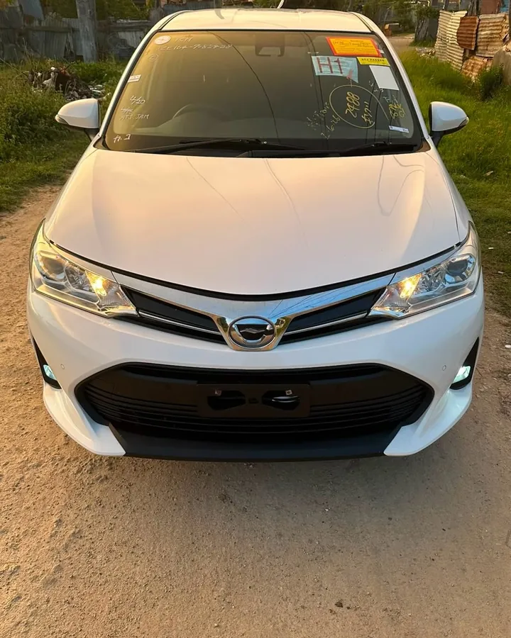 White Toyota Corolla Fielder at sunset